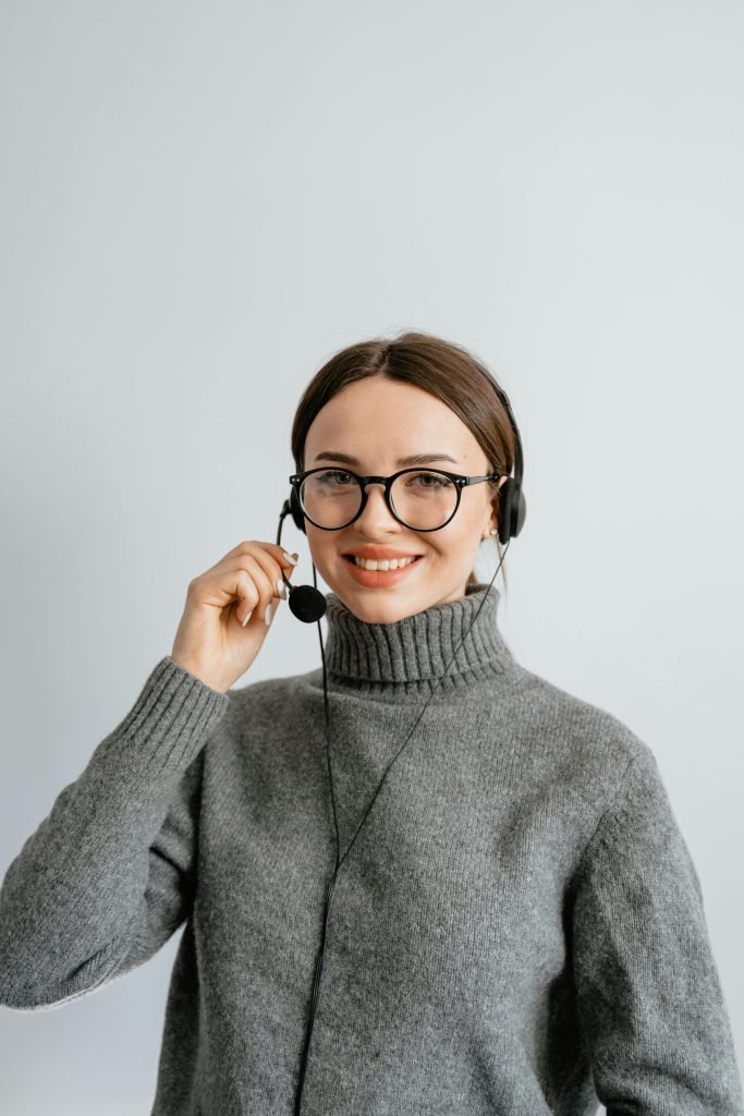 Woman in Gray Turtle Neck Shirt with Black Headset and Mouthpiece